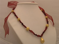 Festive red ribbon-tie necklace with 18k GP rain drop golden bea
